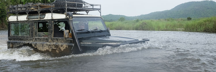 Land rover Defender crossing a river in Myanmar