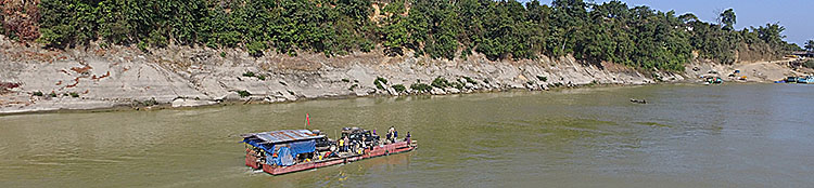 Our land rover Defender on a boat, upstream on the Chindwin river