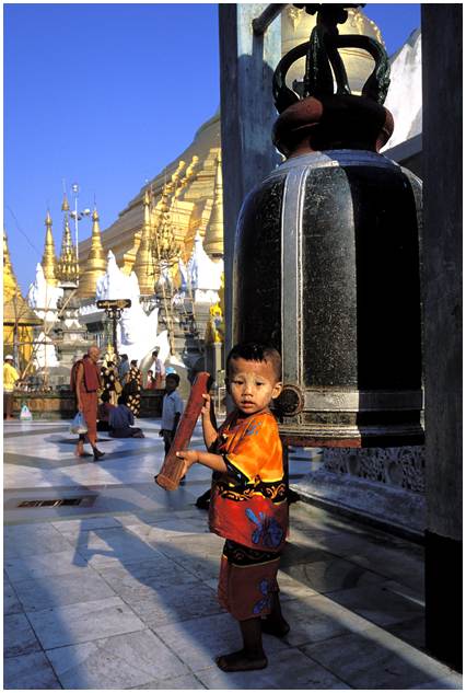 Child hitting a gong at Shwedagon, Myanmar